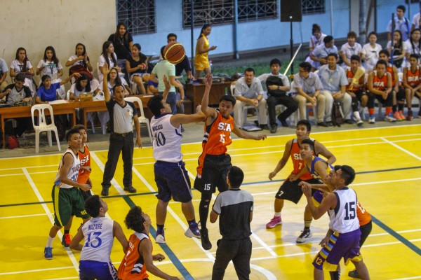 Sameer Macacua of the CS Chameleons and James Aninon of the SEA Tigers battle for the jumpball. Photo by Mark Louie Balladares