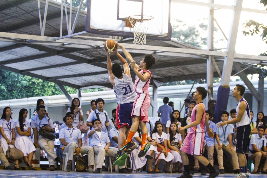 NOT IN MY HOUSE. A Social Science player blocks the shot attempt of an opposing player in the Men's basketball match last Friday. Photo by Mark Balladares