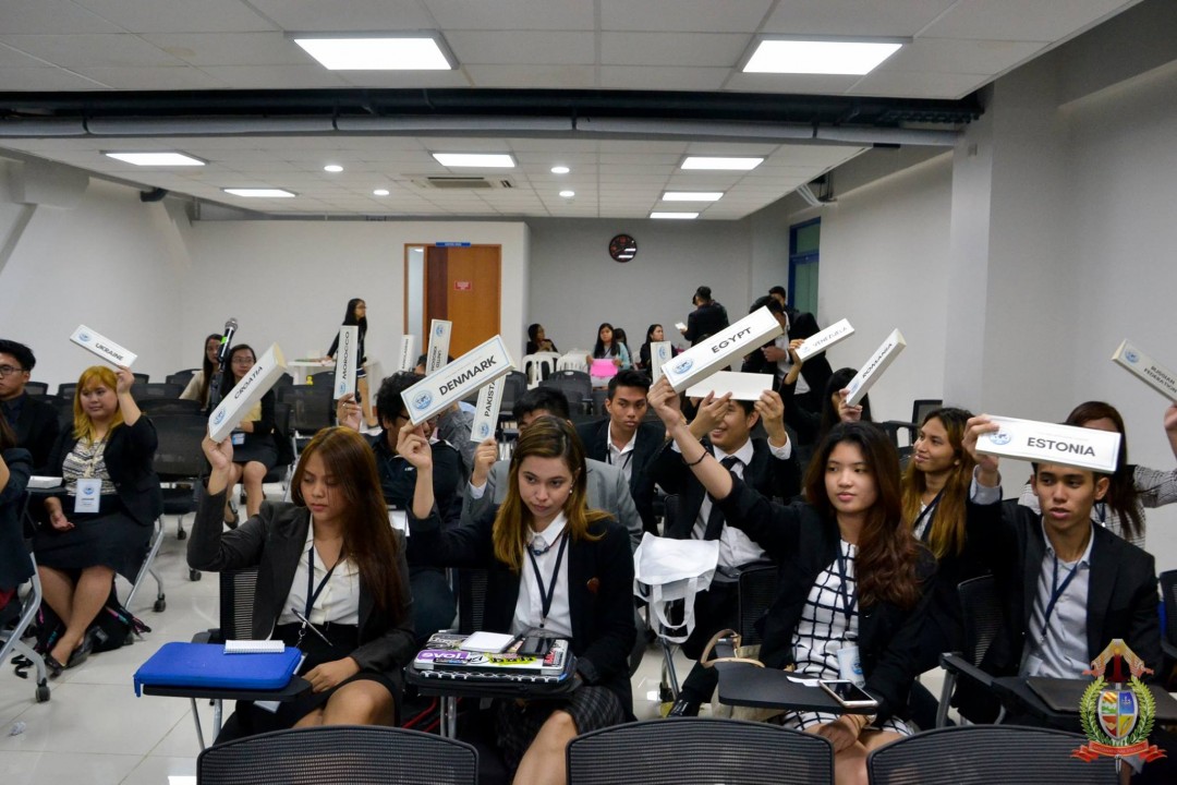 Delegates representing the different member states of the United Nations (UN) raise their placards during a plenary voting procedure. Photo from the official Facebook page of International Studies Department, Ateneo de Davao University