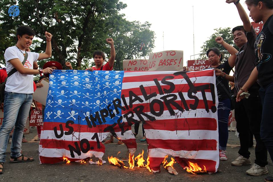 Chanting "US Imperialist, Number 1 Terrorist", progressive groups burn the national flag of USA during the commemoration of 9/11 terror attacks. 