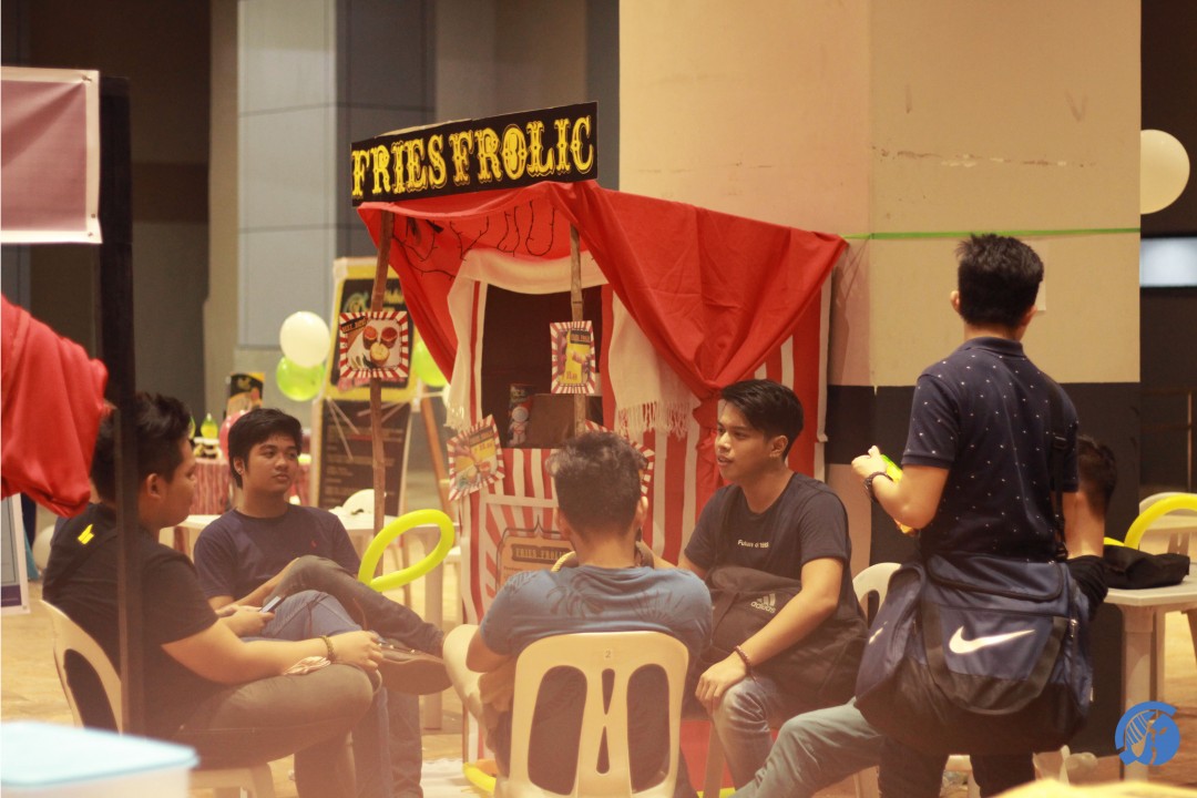 Students hang out and enjoy various food and merchandise booths prepared by Marketing program students.