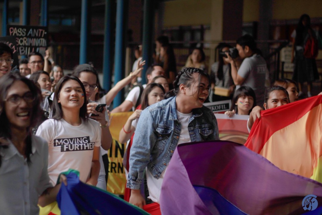 Led by drums and a huge rainbow flag, members and allies of LGBT community cheerfully march along the sidewalks of the university. Photo by Ram Manlatican