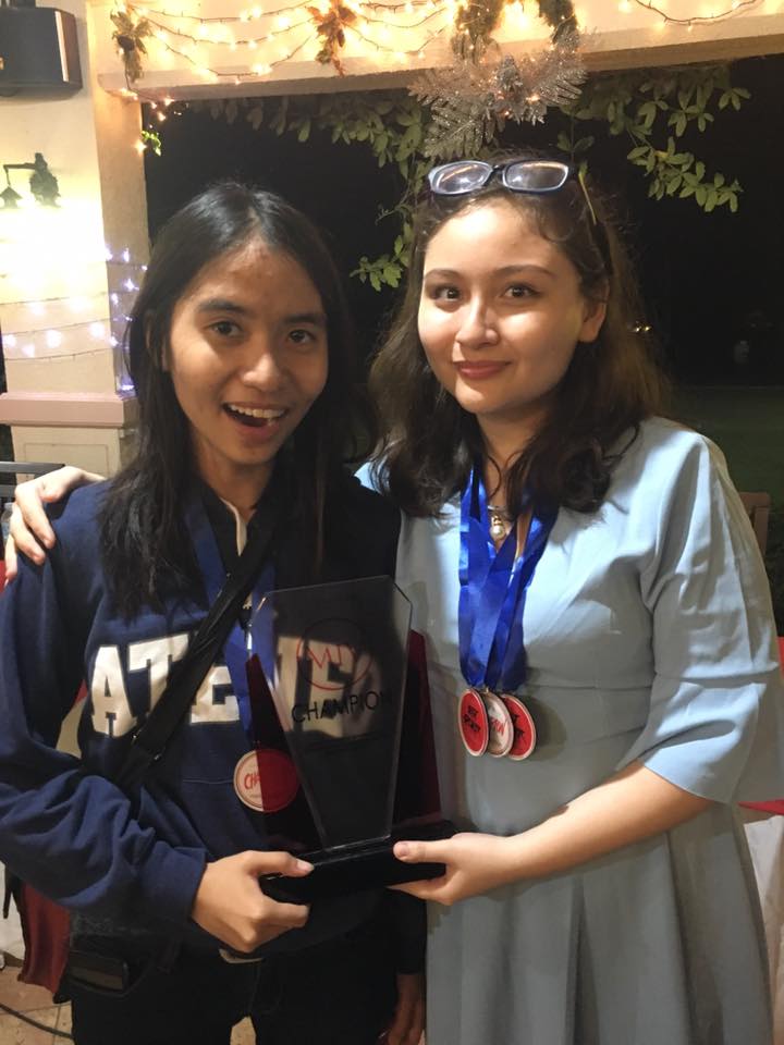 From left to right: Vanessa Kate Madrazo and Trisha Aliya Dulanas holding the championship trophy. Photo taken from the Facebook page of Reese Marban