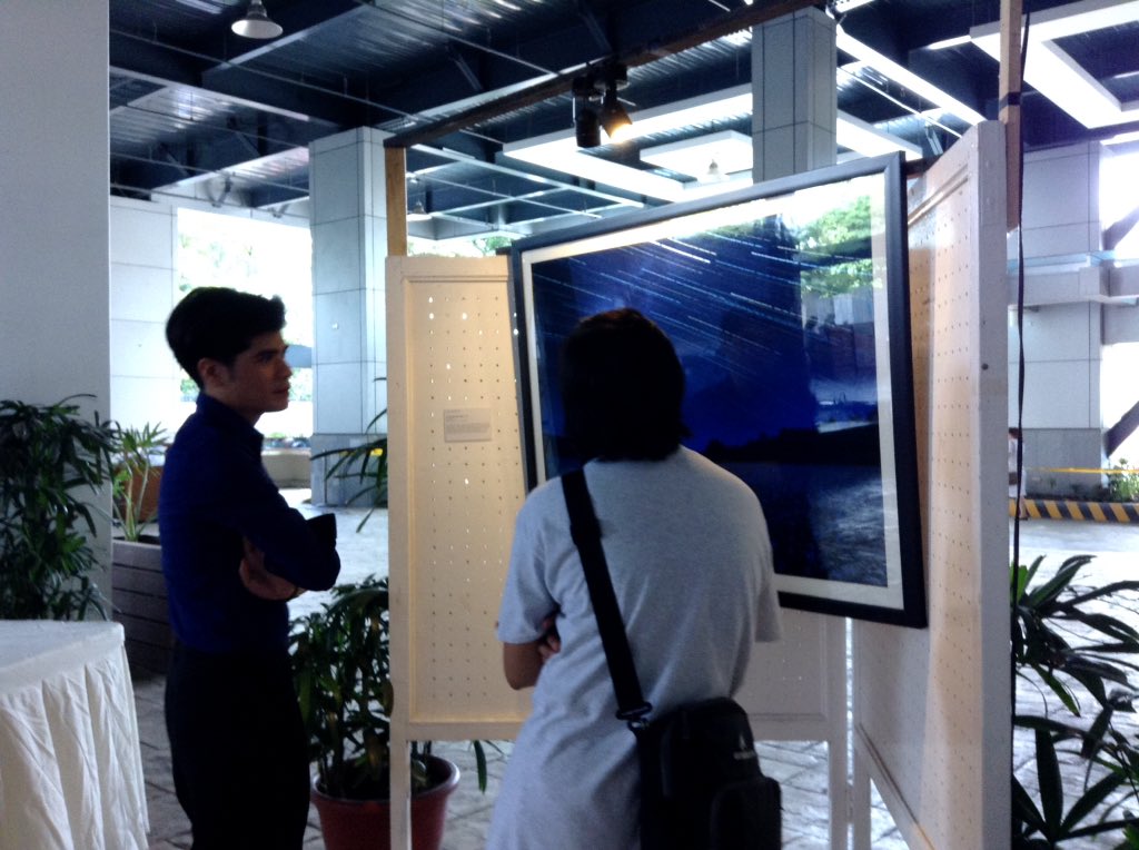 Students examining the photo exhibit. Photo taken from @ADDU_Official